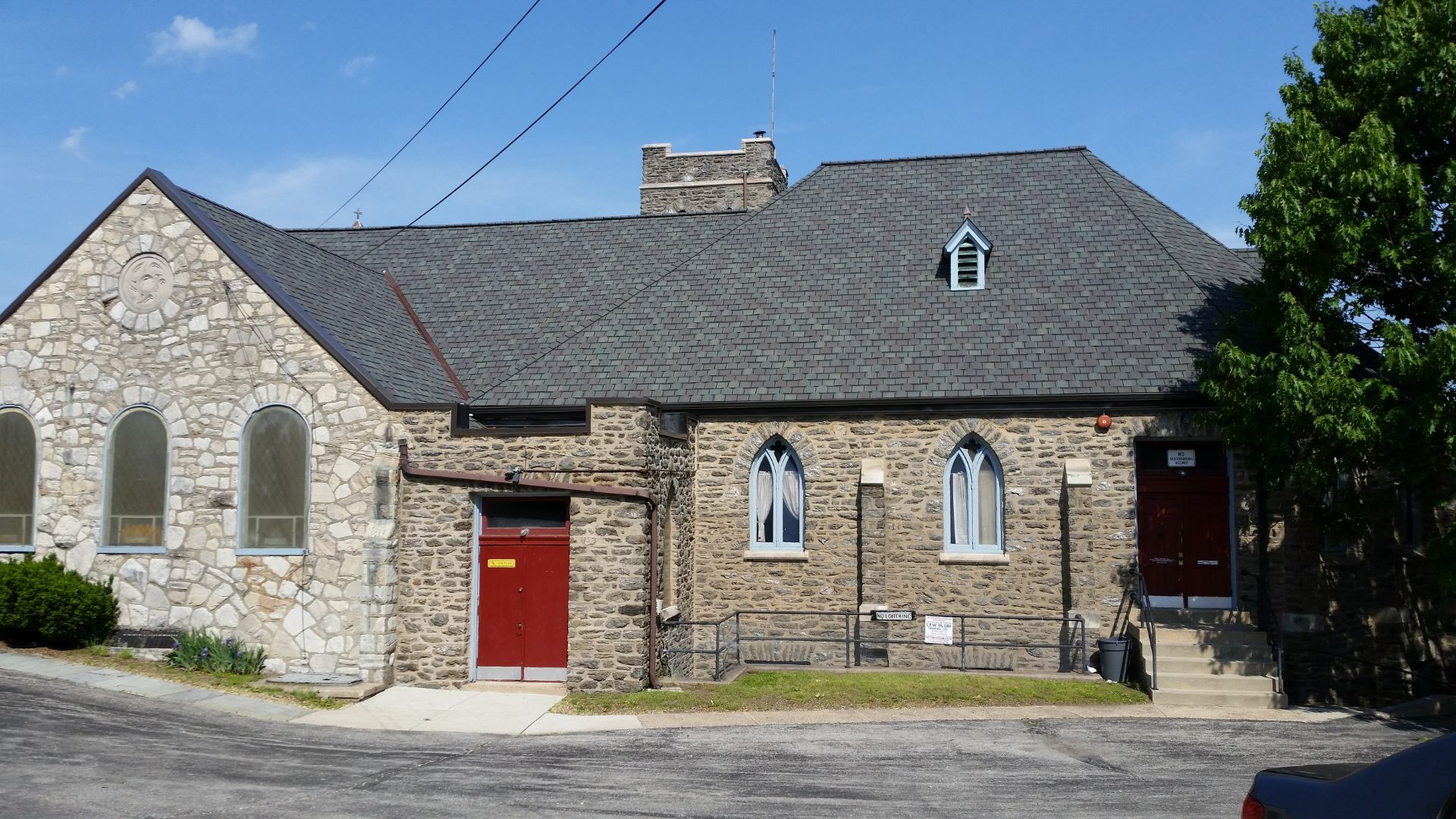 A precisely angled shingled roof on a historic stone building