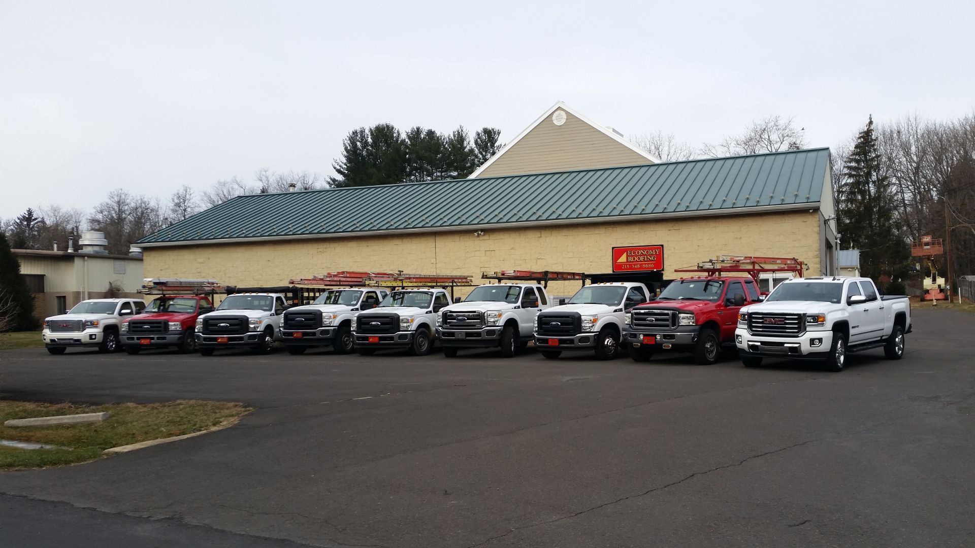 Economy Roofing Inc. Company construction trucks and vehicles