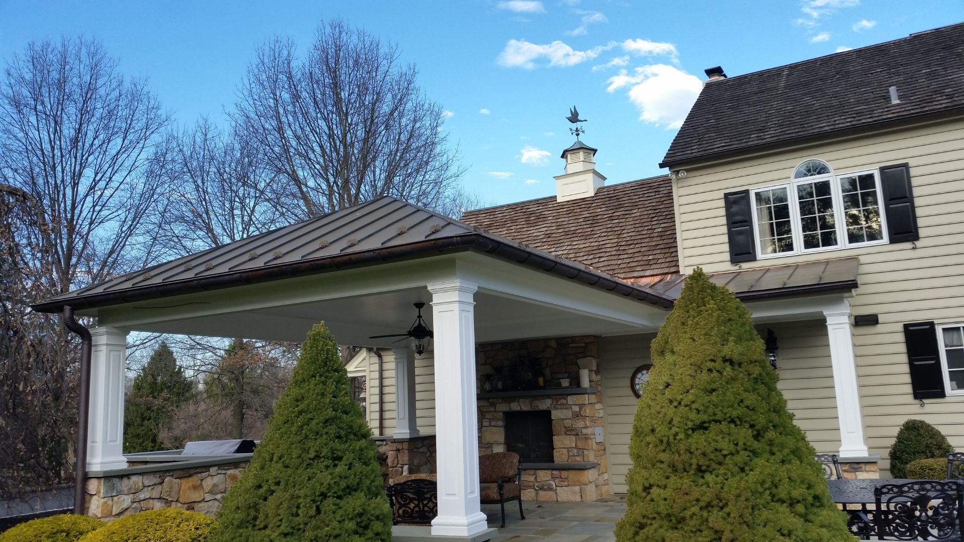 Metal roofing with snow guards over an outdoor fireplace